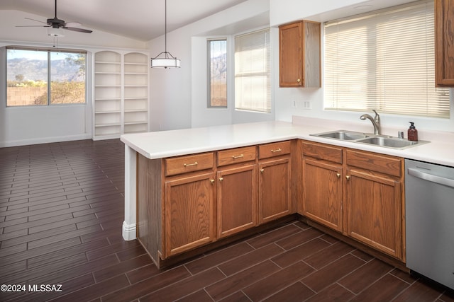 kitchen with kitchen peninsula, sink, dishwasher, hanging light fixtures, and lofted ceiling