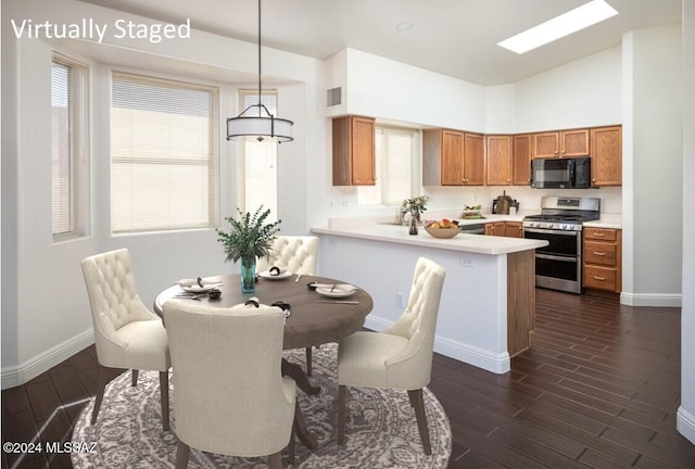 dining area with dark hardwood / wood-style flooring and high vaulted ceiling