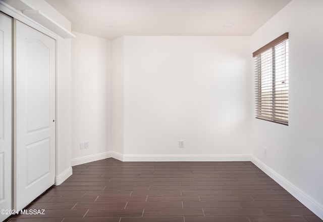 empty room with dark wood-type flooring