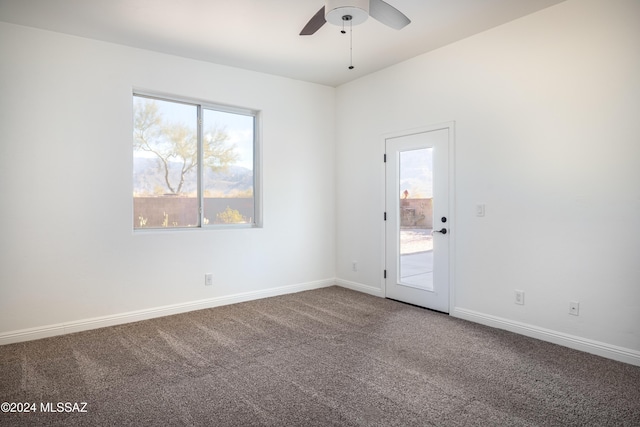 unfurnished room with ceiling fan, a healthy amount of sunlight, and carpet floors