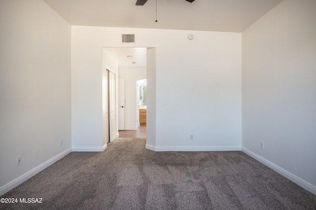 carpeted empty room featuring ceiling fan