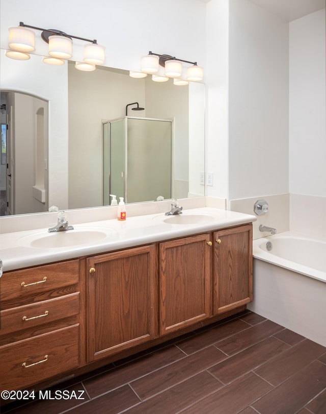 bathroom featuring vanity and separate shower and tub