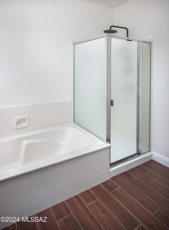 bathroom featuring wood-type flooring and independent shower and bath