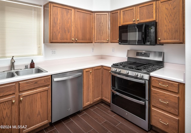 kitchen featuring stainless steel appliances, dark hardwood / wood-style floors, and sink