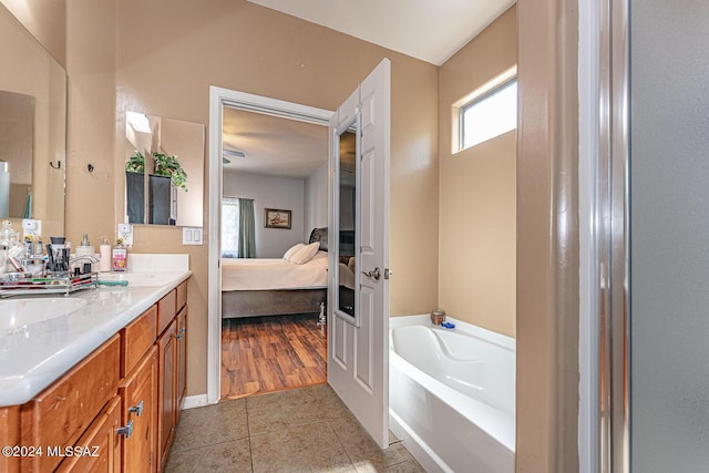 bathroom featuring a bathtub, tile patterned flooring, and vanity