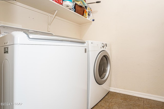 clothes washing area featuring washer and clothes dryer