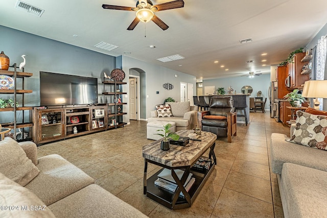 tiled living room with ceiling fan