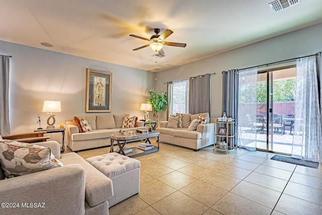 living room featuring light tile patterned floors and ceiling fan