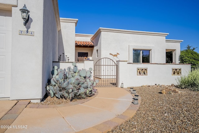 206 Circulo Veranera, Tubac, AZ 85646 - view of front of home with a gate, stucco siding, and a tile roof
