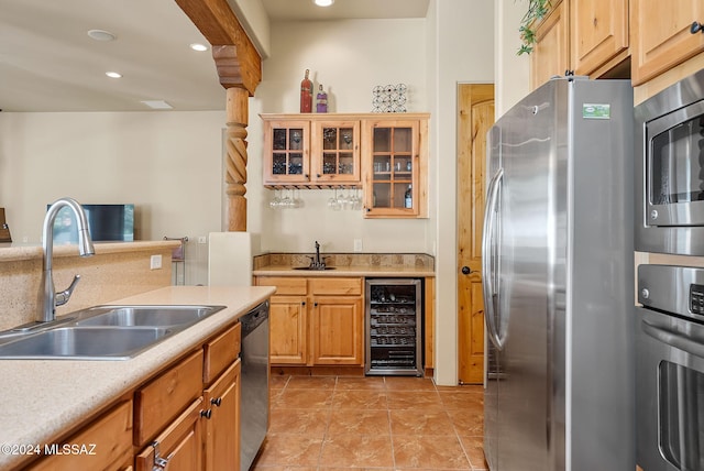 kitchen with appliances with stainless steel finishes, wine cooler, and sink