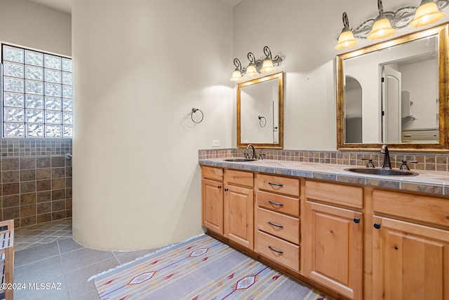 bathroom featuring tile patterned floors, vanity, and tile walls