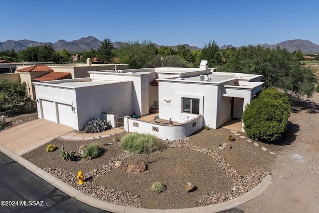 206 Circulo Veranera, Tubac, AZ 85646 - view of front of home with a chimney, a mountain view, stucco siding, and an attached garage