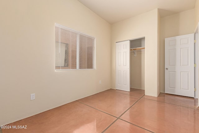 unfurnished bedroom with tile patterned floors and a closet