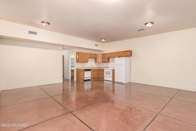 kitchen featuring white appliances and sink