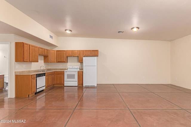 kitchen featuring tile patterned floors, sink, and white appliances