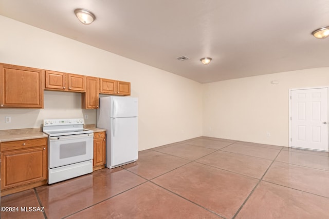 kitchen with light tile patterned floors and white appliances