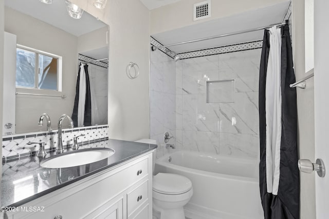 full bathroom with vanity, shower / bath combination with curtain, and toilet