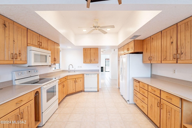 kitchen with ceiling fan, a raised ceiling, white appliances, and sink