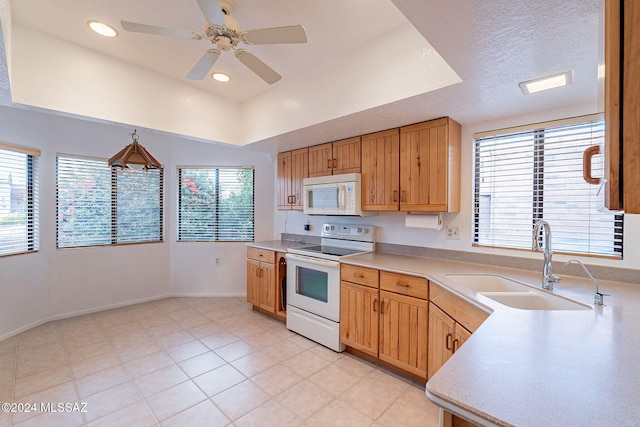 kitchen featuring pendant lighting, white appliances, sink, ceiling fan, and a textured ceiling