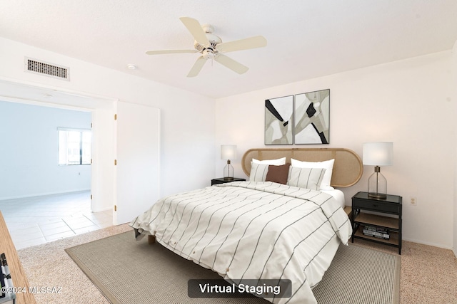 bedroom with light carpet and ceiling fan