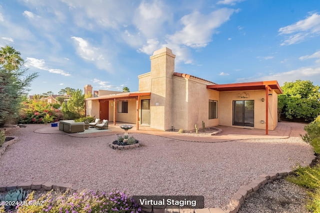 rear view of property with an outdoor hangout area and a patio