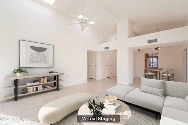 tiled living room with ceiling fan and high vaulted ceiling