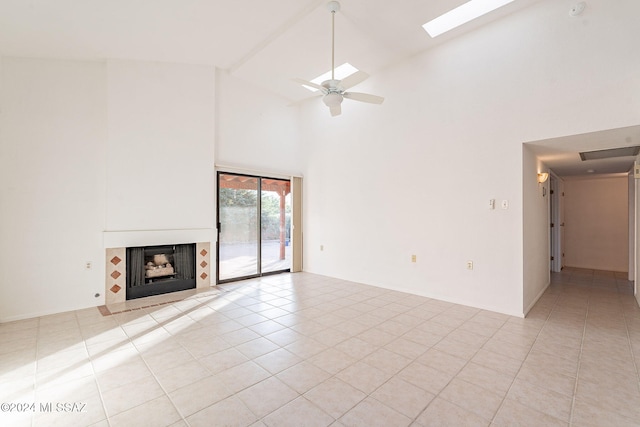 unfurnished living room featuring ceiling fan, high vaulted ceiling, and light tile patterned floors