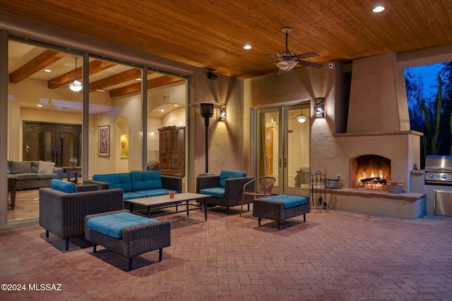 view of patio / terrace featuring an outdoor living space with a fireplace and ceiling fan