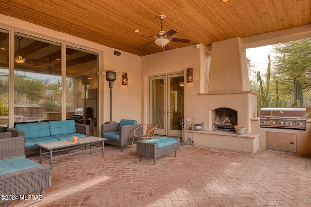 view of patio featuring an outdoor living space with a fireplace, area for grilling, and french doors