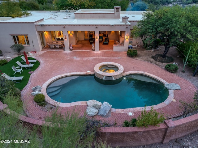 view of pool featuring a patio area and an in ground hot tub