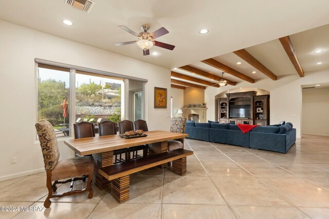 dining area featuring beam ceiling and ceiling fan