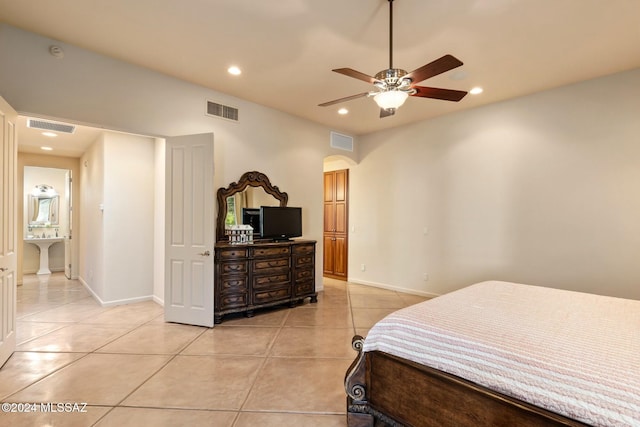 tiled bedroom featuring ceiling fan and ensuite bathroom