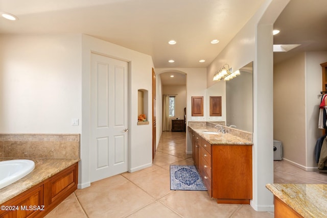 bathroom with vanity, tile patterned floors, and a bathing tub