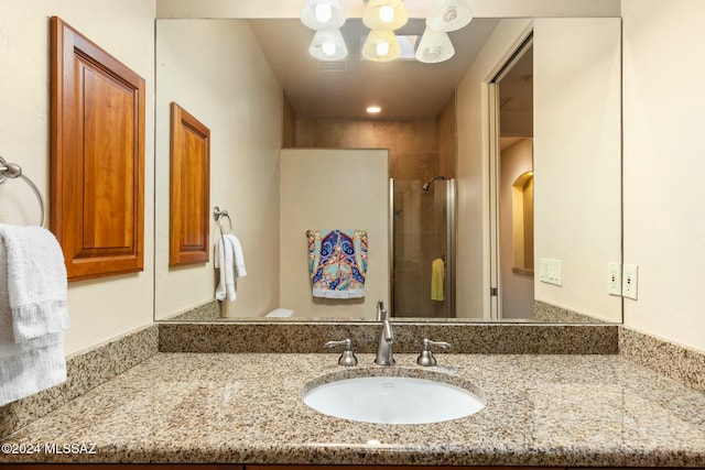 bathroom featuring vanity and an enclosed shower