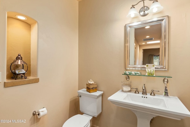 bathroom with toilet and sink