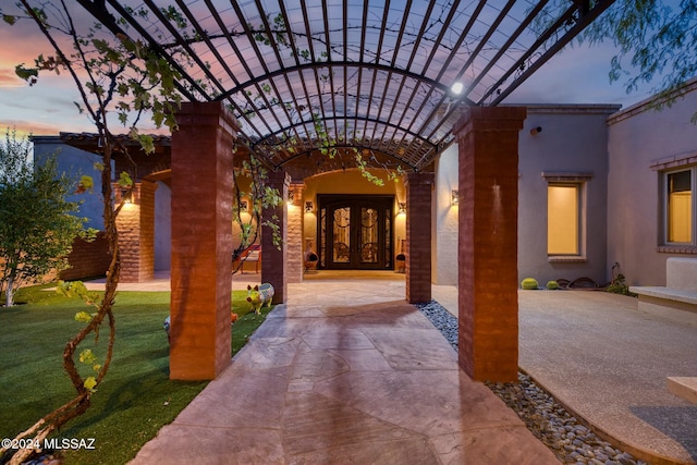 exterior entry at dusk with french doors