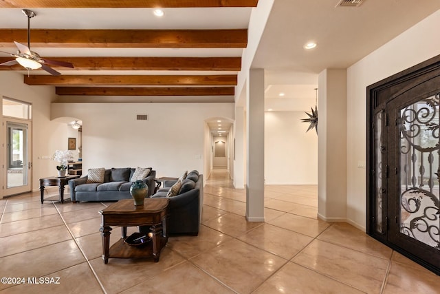 interior space featuring ceiling fan and beam ceiling