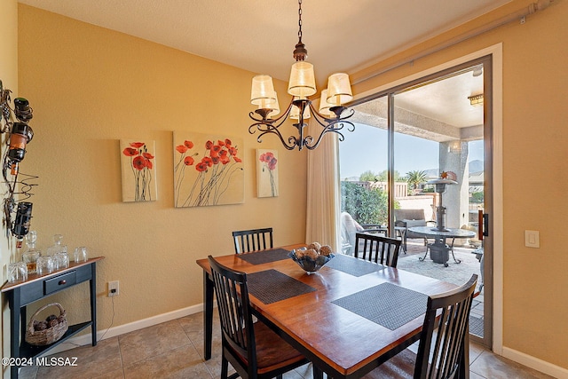 tiled dining area featuring a notable chandelier