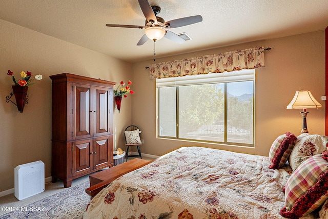 bedroom featuring light carpet and ceiling fan