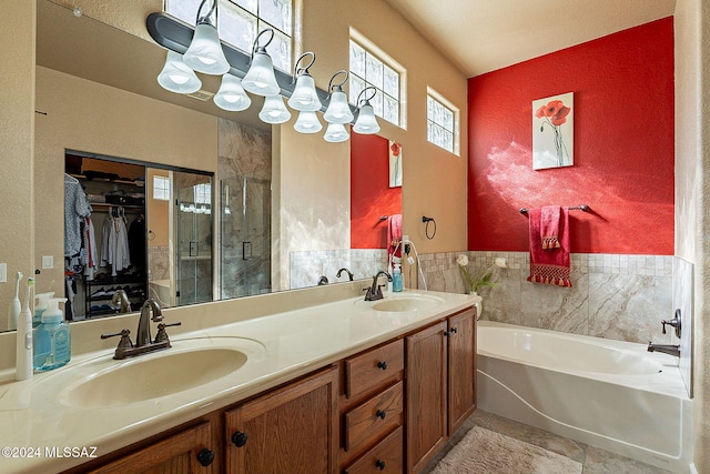 bathroom featuring separate shower and tub and vanity