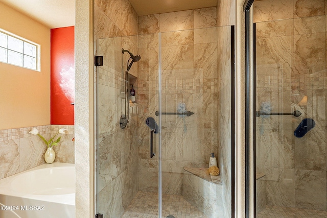 bathroom featuring independent shower and bath