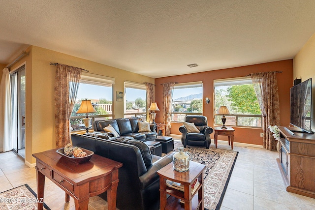 living room with light tile patterned floors and a textured ceiling