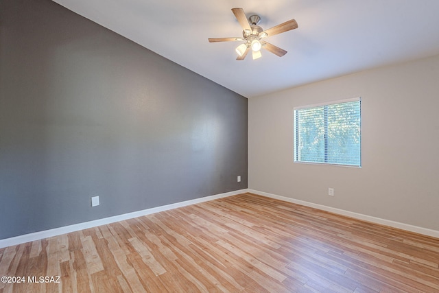 unfurnished room featuring ceiling fan, lofted ceiling, and light hardwood / wood-style flooring