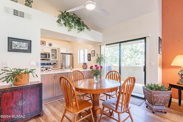 dining area with ceiling fan and light hardwood / wood-style flooring