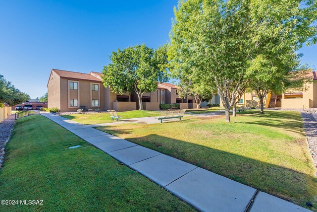 view of property's community with a lawn