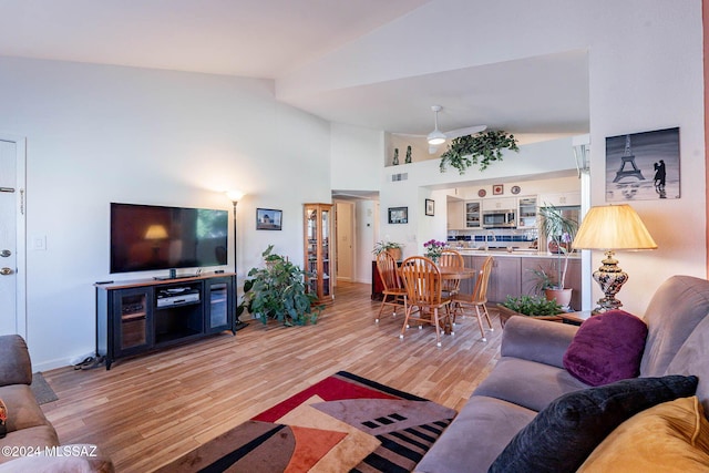 living room featuring hardwood / wood-style floors and high vaulted ceiling