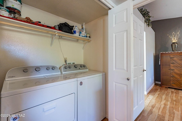 laundry area with light wood-type flooring and separate washer and dryer