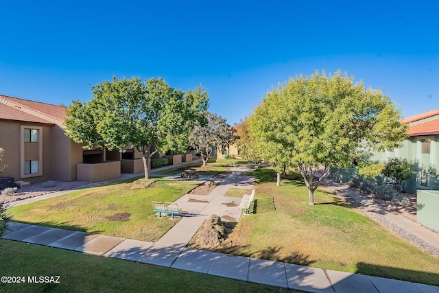 view of home's community with a lawn