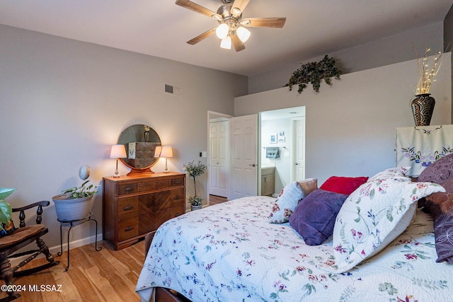 bedroom with ensuite bath, light hardwood / wood-style flooring, and ceiling fan