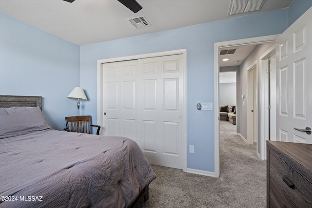 bedroom with ceiling fan, a closet, and light colored carpet